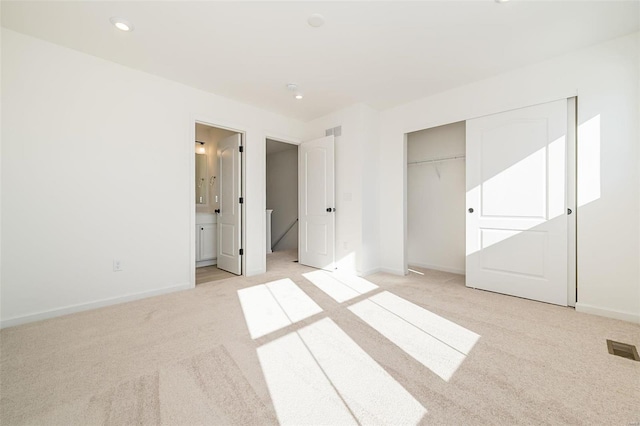 unfurnished bedroom featuring light carpet, visible vents, and baseboards