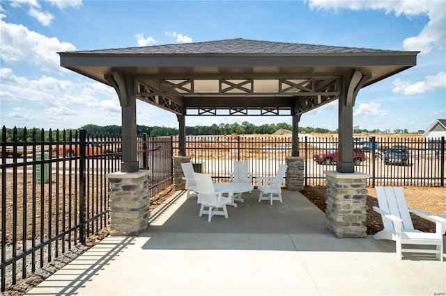 view of patio / terrace with fence and a gazebo