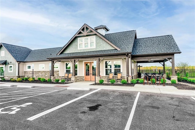 view of property with uncovered parking and fence