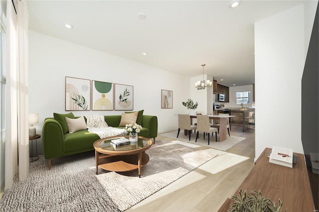 living room featuring wood-type flooring and an inviting chandelier