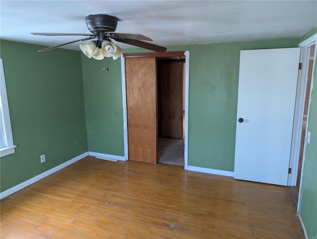 interior space featuring light wood-type flooring, ceiling fan, and a closet