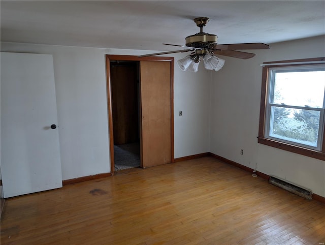 empty room with light hardwood / wood-style floors and ceiling fan