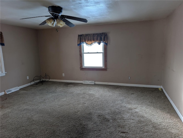 carpeted spare room featuring ceiling fan