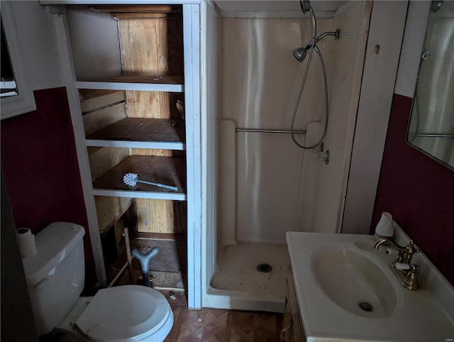 bathroom with walk in shower, toilet, parquet floors, and vanity