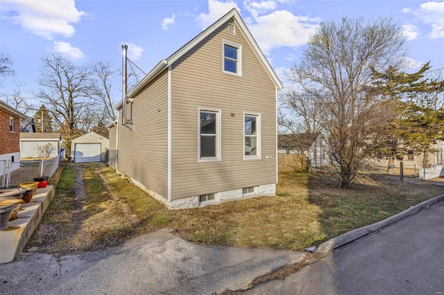 view of property exterior featuring an outbuilding and a garage