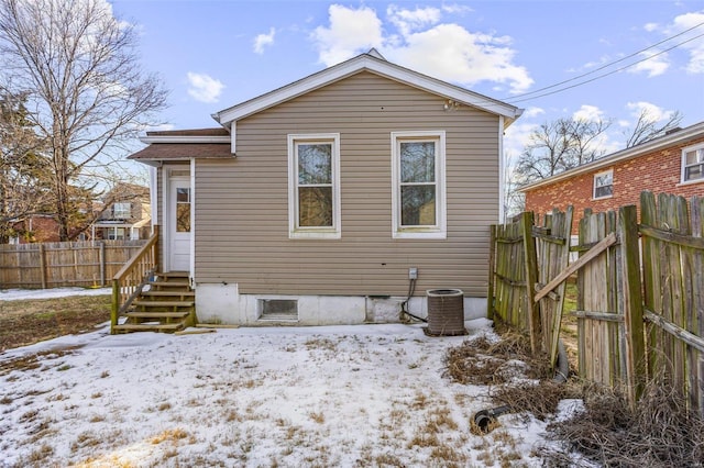 snow covered property featuring central air condition unit