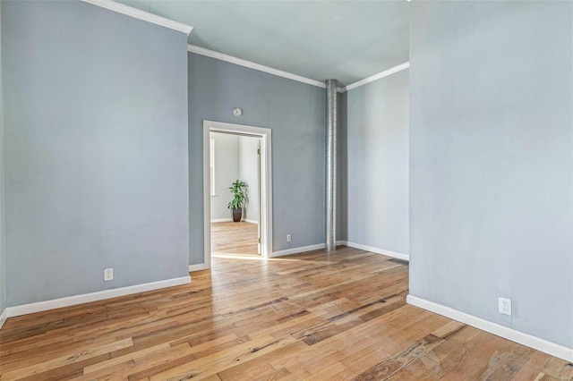 empty room with light hardwood / wood-style flooring and ornamental molding