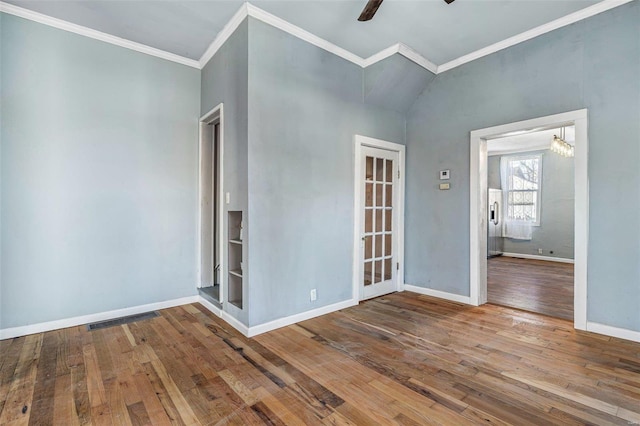 empty room with hardwood / wood-style floors, ornamental molding, and ceiling fan