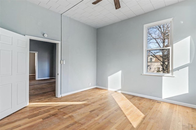 spare room featuring hardwood / wood-style flooring and ceiling fan