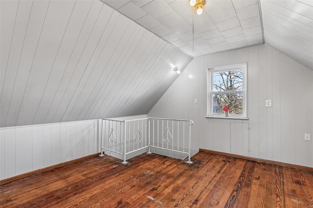 additional living space with lofted ceiling and dark hardwood / wood-style floors