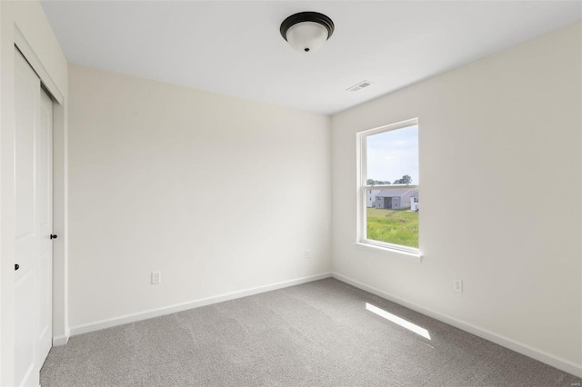 unfurnished bedroom with carpet and a closet