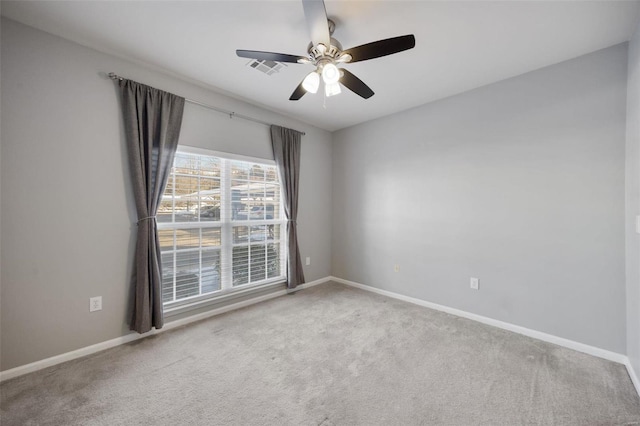 carpeted spare room featuring ceiling fan