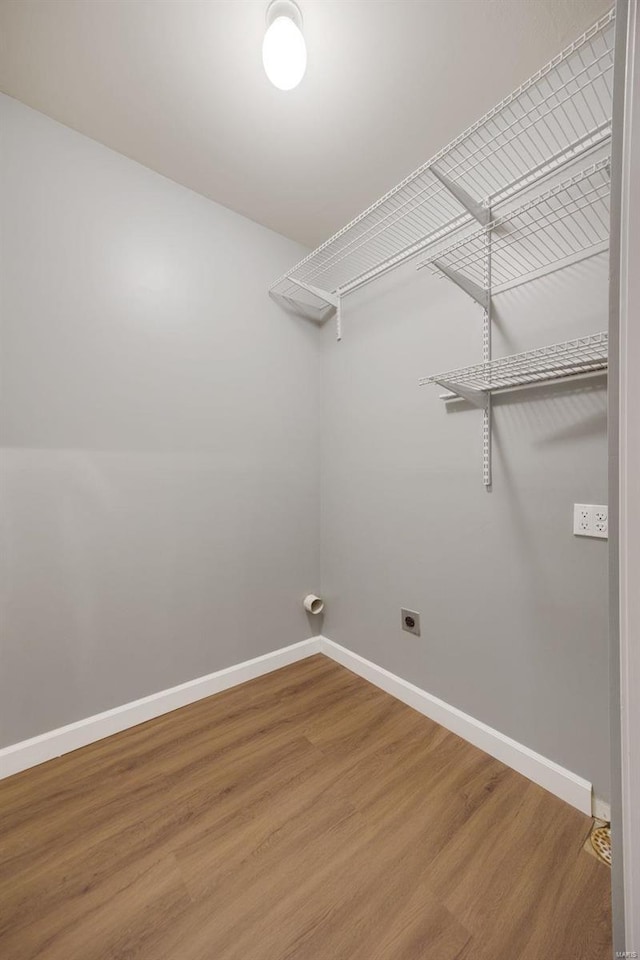 washroom featuring hookup for an electric dryer and wood-type flooring