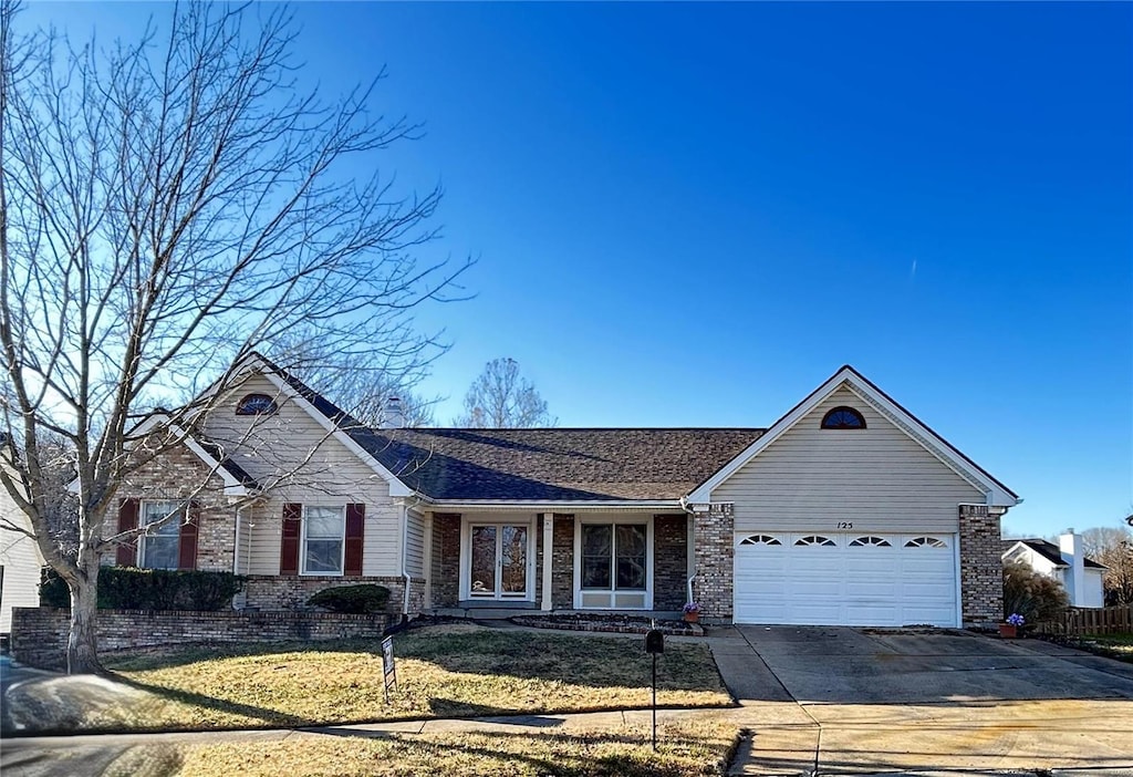 ranch-style home with a front yard and a garage