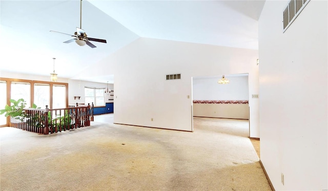 unfurnished room featuring ceiling fan, high vaulted ceiling, and light colored carpet