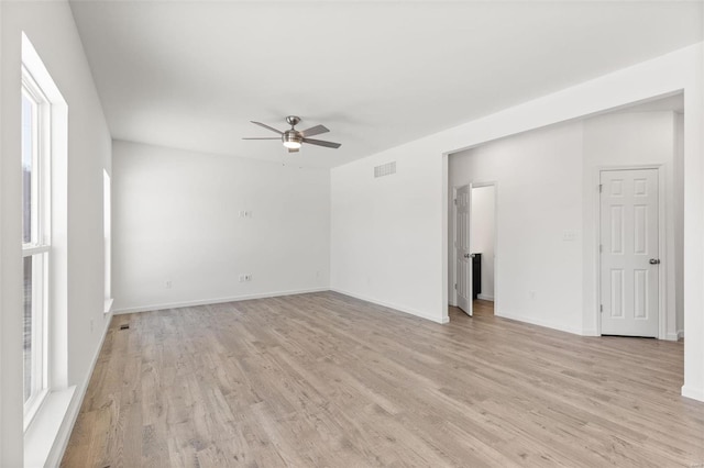 empty room with light wood-type flooring and ceiling fan