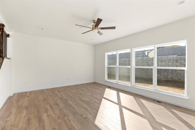 unfurnished room with ceiling fan and light hardwood / wood-style flooring