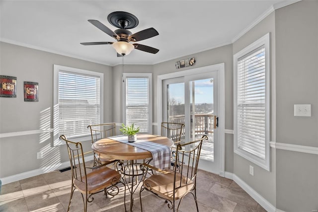 dining area with ceiling fan, a healthy amount of sunlight, and crown molding