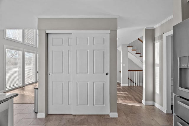 interior space featuring ornamental molding, light stone countertops, and light tile patterned floors