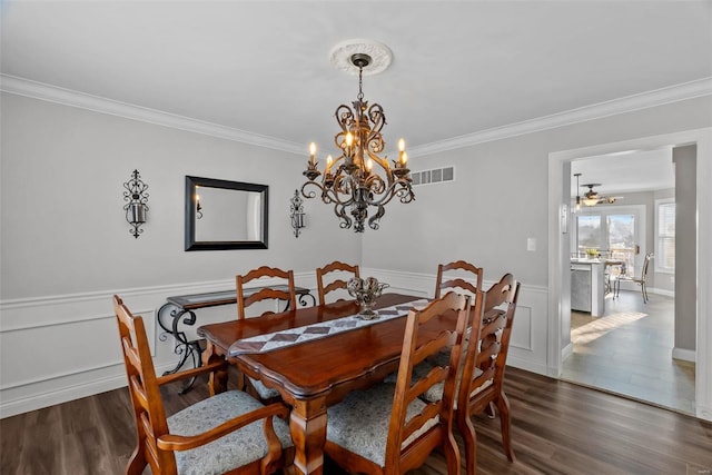 dining space featuring a chandelier, crown molding, and dark hardwood / wood-style floors