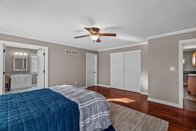 bedroom with ensuite bath, ceiling fan, a closet, dark hardwood / wood-style flooring, and crown molding