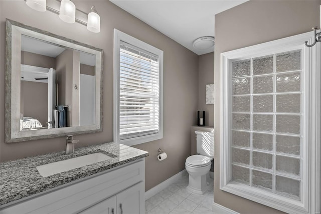 bathroom featuring toilet, vanity, and tile patterned flooring