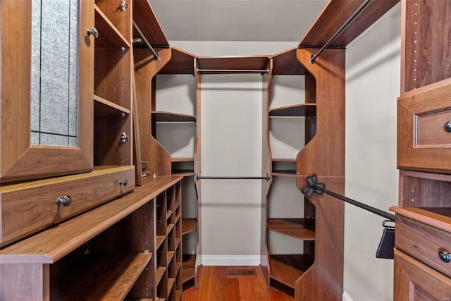 walk in closet featuring hardwood / wood-style flooring