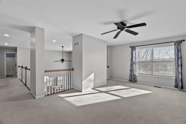 unfurnished room featuring ceiling fan and light carpet