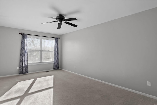 carpeted empty room featuring ceiling fan