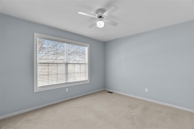 unfurnished room featuring ceiling fan and light carpet