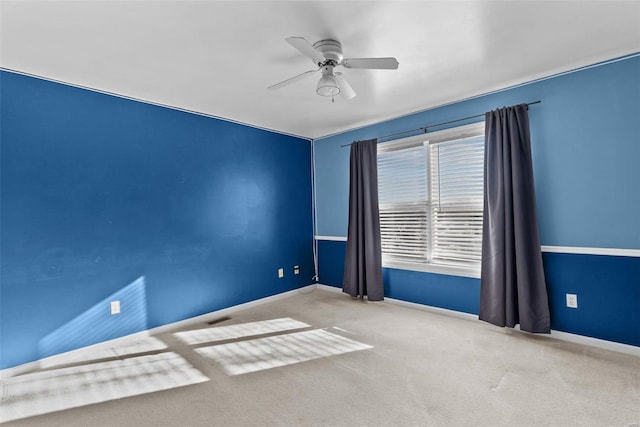 carpeted empty room featuring ceiling fan