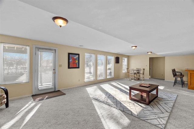 living room featuring a wealth of natural light and light carpet