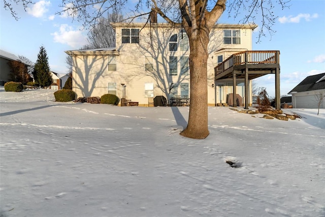 rear view of property featuring a wooden deck