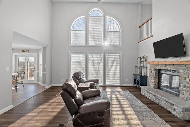 living room featuring dark hardwood / wood-style flooring, plenty of natural light, and a fireplace