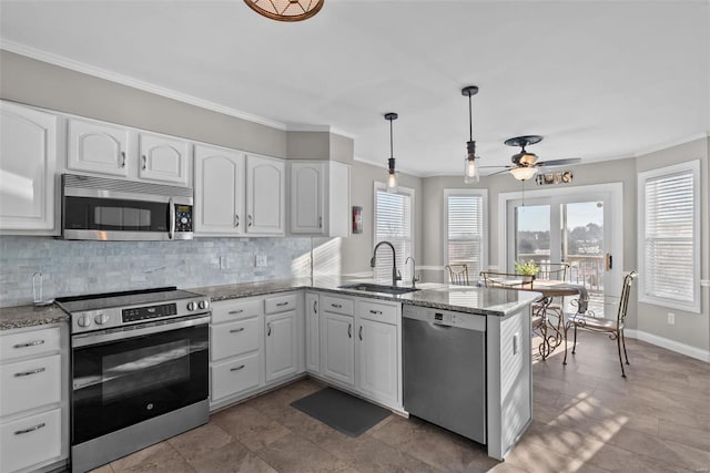 kitchen with stainless steel appliances, white cabinets, sink, and kitchen peninsula