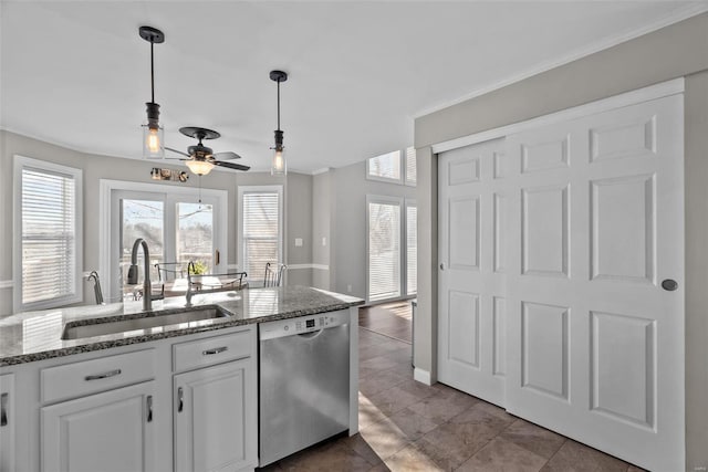 kitchen featuring hanging light fixtures, ceiling fan, white cabinets, stainless steel dishwasher, and sink