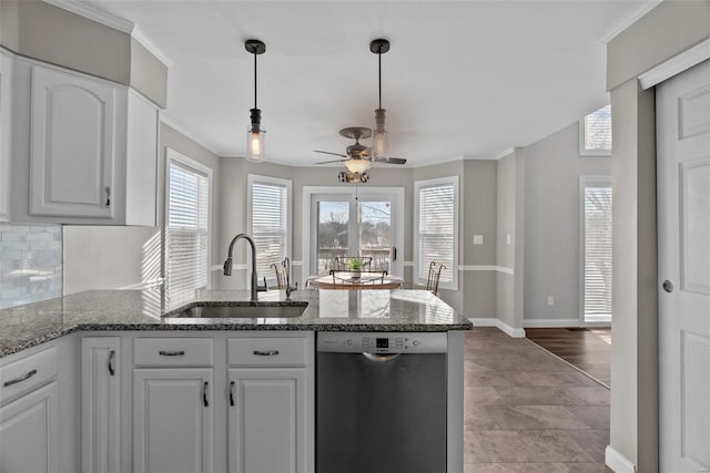 kitchen with stainless steel dishwasher, tasteful backsplash, white cabinetry, ceiling fan, and sink