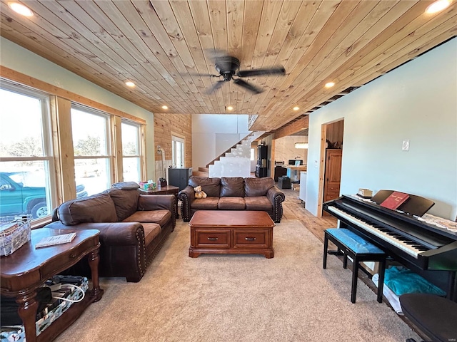 living room with ceiling fan, wood ceiling, and light carpet