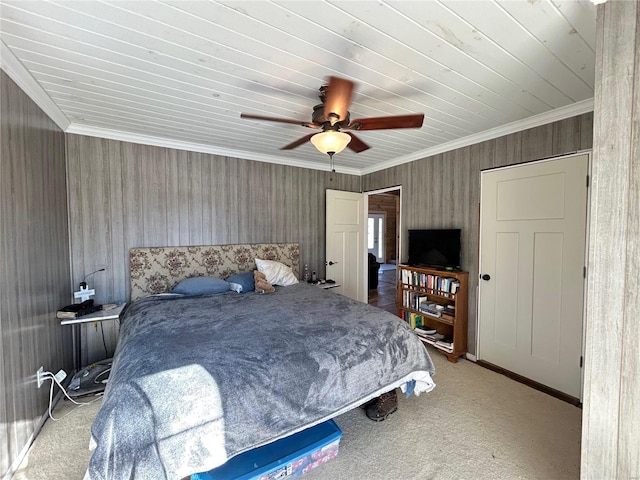 carpeted bedroom featuring ceiling fan and crown molding