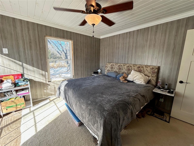 carpeted bedroom with ceiling fan and crown molding