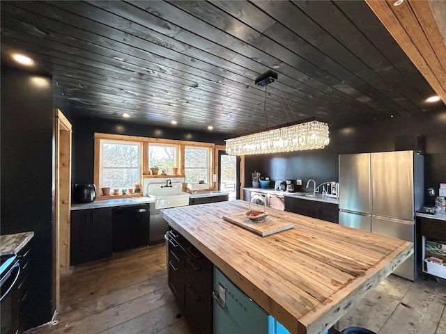 kitchen featuring pendant lighting, a center island, wooden ceiling, stainless steel fridge, and light hardwood / wood-style floors