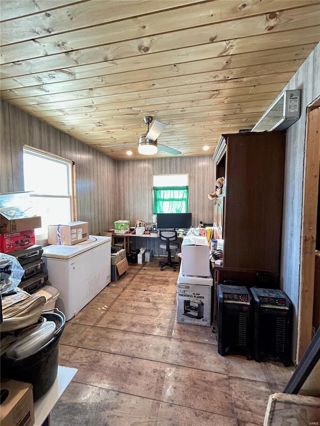 interior space featuring hardwood / wood-style floors, ceiling fan, wood walls, and wood ceiling