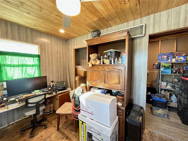 office space with hardwood / wood-style flooring, ceiling fan, and wooden walls