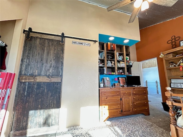 kitchen with a barn door and ceiling fan