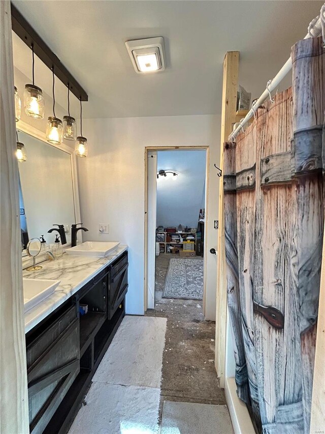 bathroom featuring concrete flooring and vanity