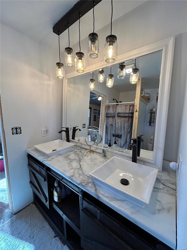 bathroom featuring a shower with curtain and vanity