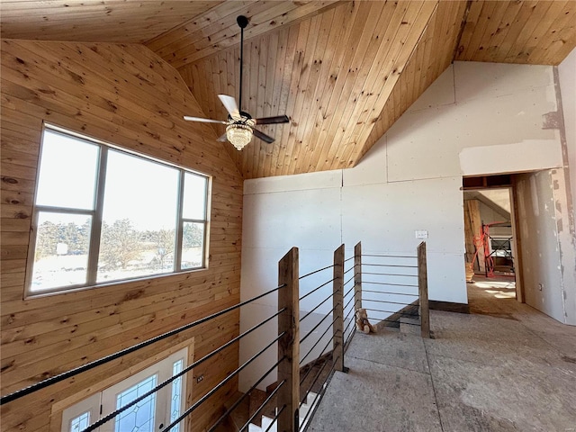 interior space featuring wood ceiling, ceiling fan, lofted ceiling, and wood walls