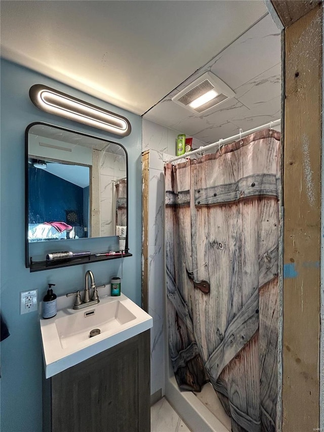 bathroom featuring curtained shower and vanity