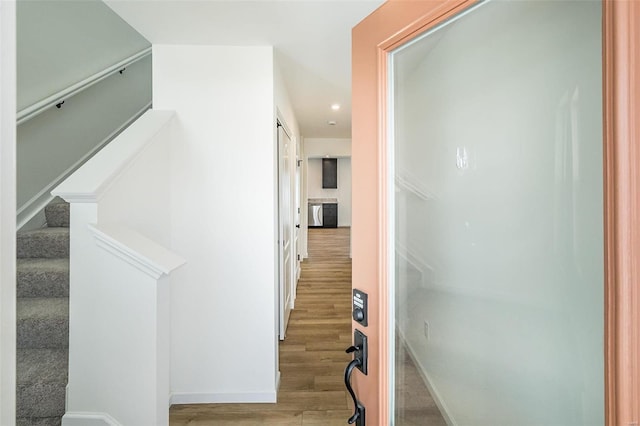 hallway with light hardwood / wood-style flooring