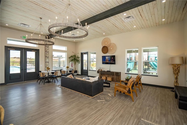 living room with dark wood-type flooring, french doors, a towering ceiling, and wood ceiling